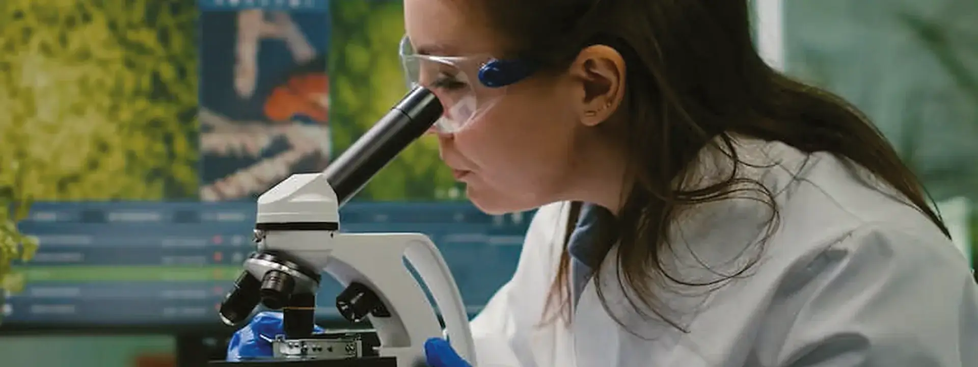 A scientist looking through a microscope in a laboratory